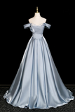 Silver evening gown on a mannequin against a black background