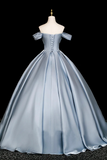 Blue satin evening gown on a mannequin against a black background