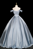 Silver evening gown on a mannequin against a black background