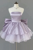 Lavender strapless dress with a large bow on a mannequin against a gray background