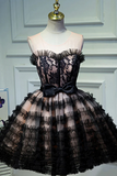 Black lace dress on a mannequin against a light gray wall