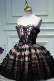 Black lace dress on a mannequin against a white wall