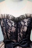 Black lace corset with a bow on a neutral background