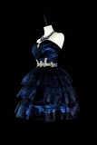 Navy blue evening gown with a beaded waistband on a mannequin against a black background