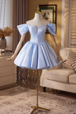 Light blue dress on a mannequin in a room with a couch and decor.
