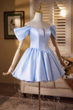 Light blue off-shoulder dress on a mannequin in a room setting.
