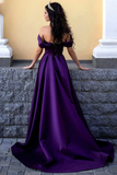 Woman in a purple evening gown standing on stone steps with a yellow wall in the background