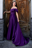 Woman in a purple evening gown standing in front of an ornate wooden door.