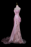 Pink evening gown on a mannequin against a black background