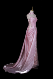 Pink evening gown on a mannequin against a black background