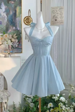 Light blue dress on a mannequin with floral decorations and a painting in the background