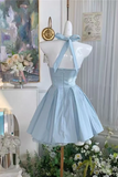 Light blue dress on a mannequin with floral decorations and a painting in the background