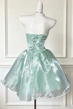 Mint green strapless dress on a mannequin against a white wall.
