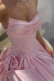 Pink evening gown with embellishments on a neutral background