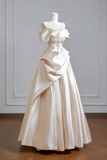 White wedding dress on a mannequin against a plain background