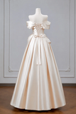 White wedding dress on a mannequin against a gray wall.