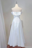 White strapless evening gown on a mannequin against a plain background