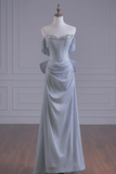 Light blue evening gown on a mannequin against a gray wall.