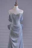 Light blue evening gown on a mannequin against a gray background