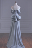 Gray evening gown on a mannequin against a gray wall.