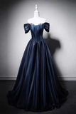 Navy blue evening gown on a mannequin against a gray background