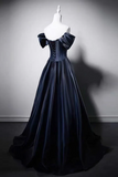 Navy blue evening gown on a mannequin against a gray background