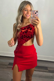 Woman taking a mirror selfie wearing a red dress with a patterned top.