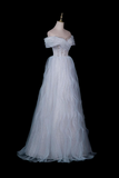 An off-the-shoulder white tulle gown displayed on a mannequin against a solid black background.