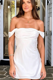 A woman wearing a white off-the-shoulder satin mini dress, standing in front of a doorway.
