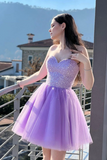 A woman wearing a sparkling strapless tulle dress with a sweetheart bodice and voluminous lavender skirt, posing on a balcony with a mountainous background.