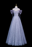 A formal off-the-shoulder ball gown displayed on a mannequin against a solid black background. The gown is a shimmering light lavender-blue color with intricate beadwork on the bodice and a sheer matching veil attached to the shoulders.