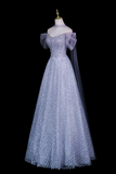 A formal off-the-shoulder ball gown displayed on a mannequin against a solid black background. The gown is a light lavender-blue color with intricate silver sequin and bead embroidery throughout, featuring a sheer tulle overskirt with a matching sheer veil.