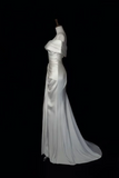 A white satin off-the-shoulder evening gown displayed on a mannequin against a solid black background.
