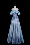 A shimmering off-the-shoulder formal gown in shades of light blue and silver, displayed on a mannequin against a solid black background.