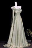 A floor-length satin gown in a pale sage green color with a subtle metallic sheen, displayed on a white mannequin against a black background.