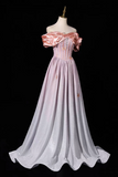 A floor-length off-the-shoulder gown displayed on a mannequin against a black background. The dress has a pale pink satin bodice with puffed sleeves and a fitted waist, transitioning into a flowing light lavender-pink skirt with subtle tonal embroidery.