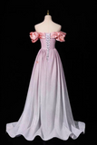 A long off-the-shoulder gown displayed on a mannequin against a black background. The dress has a pale pink satin bodice with puffed sleeves, a lace-up back, and a flowing light lavender skirt with a slight train.