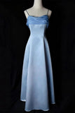 A light blue satin formal gown with spaghetti straps and a draped sweetheart neckline, displayed on a mannequin against a black background.