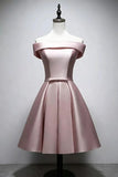 A light pink satin off-the-shoulder short dress displayed on a white mannequin torso against a plain light gray wall.