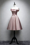 A light pink satin off-the-shoulder A-line dress displayed on a mannequin torso with a black stand against a gray studio wall.