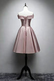 A short off-the-shoulder satin dress in a dusty pink color, displayed on a white mannequin torso with a black stand against a gray studio background.
